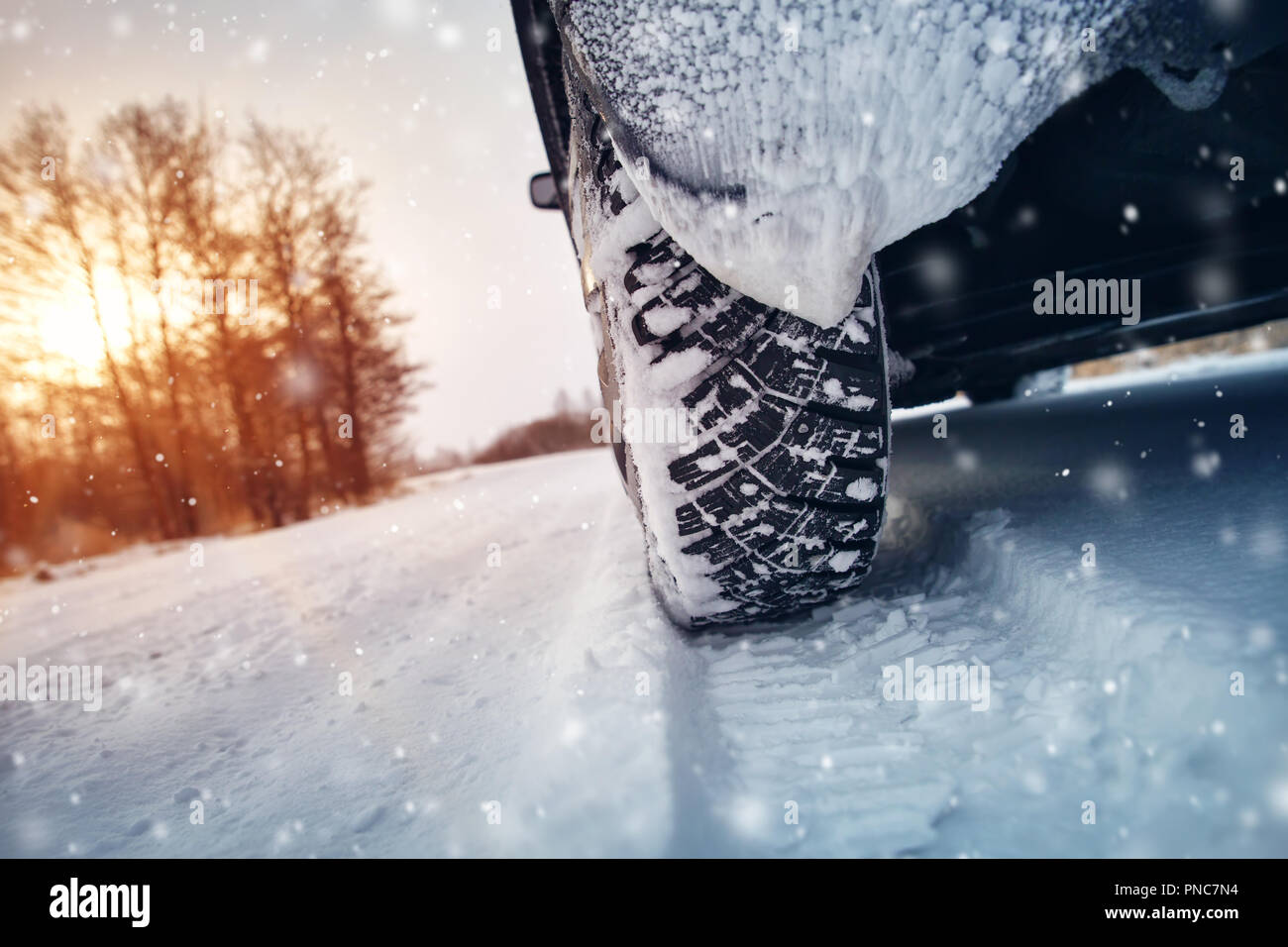 Car tires on winter road covered with snow Stock Photo - Alamy