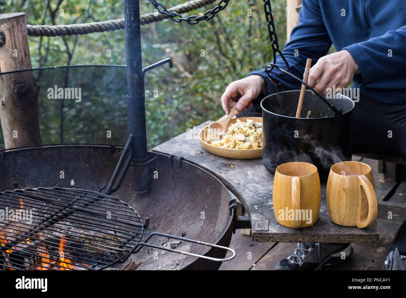 Frying pan and a pot on the fire, cooking pasta while camping Stock