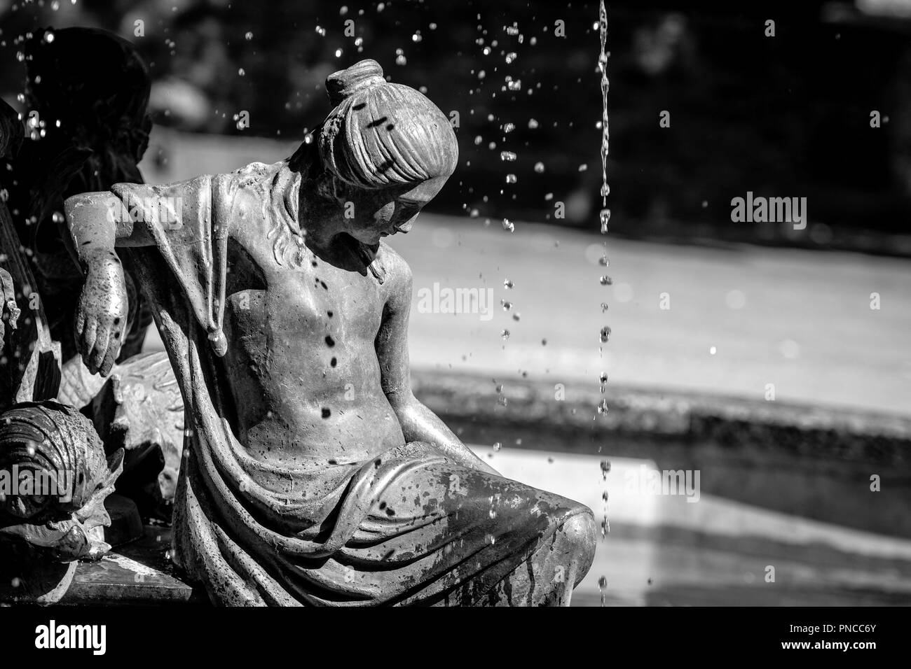 Fountain with a young girl sculpture. Stock Photo