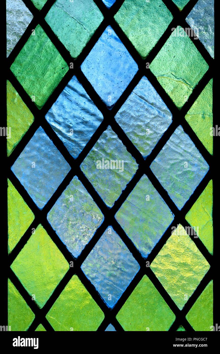 Diagonally patterned stained translucent glass window pane detail Stock