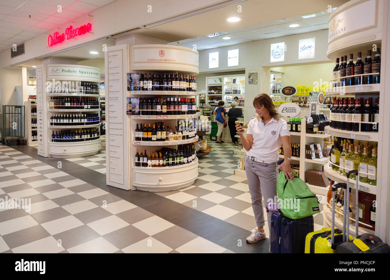 People in the Duty Free Shop, the terminal interior, Pisa International Airport, Pisa, Tuscany, Italy Europe Stock Photo