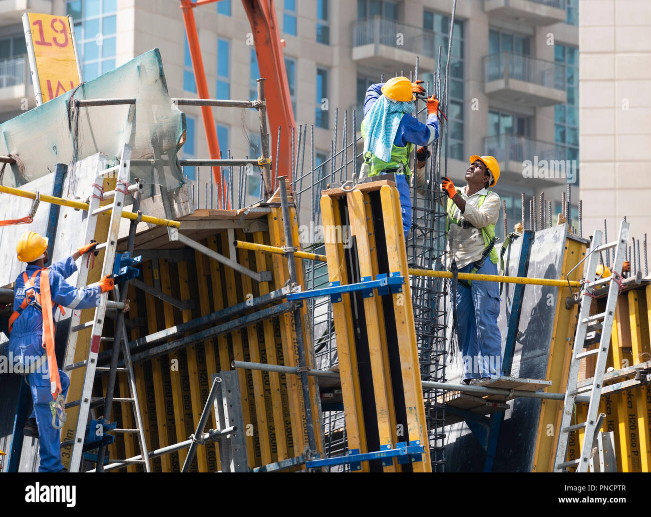 Construction workers on site building new high rise luxury apartment building art Downtown Dubai, UAE, united Arab Emirates Stock Photo