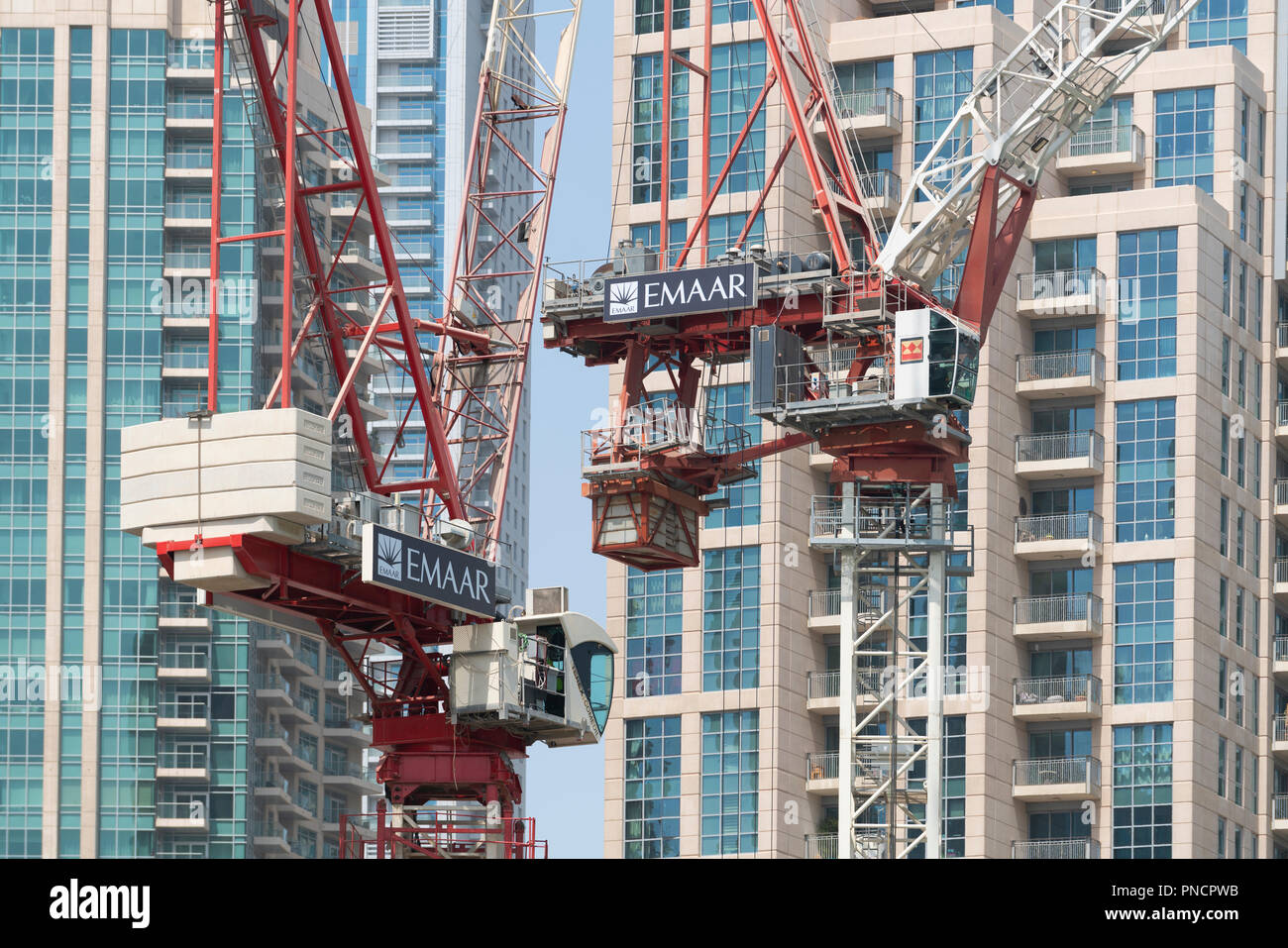 Construction cranes on construction site building new high rise apartment towers in Downtown Dubai, UAE, United Arab Emirates, Stock Photo