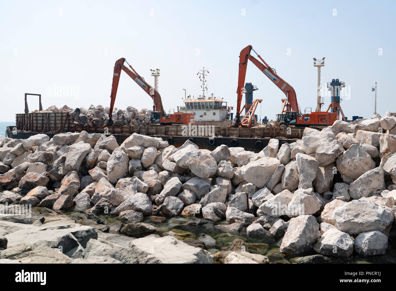 Sea defence construction work by placed large stones on shore on The Palm Jumeirah island in Dubai , United Arab Emirates, UAE. Stock Photo