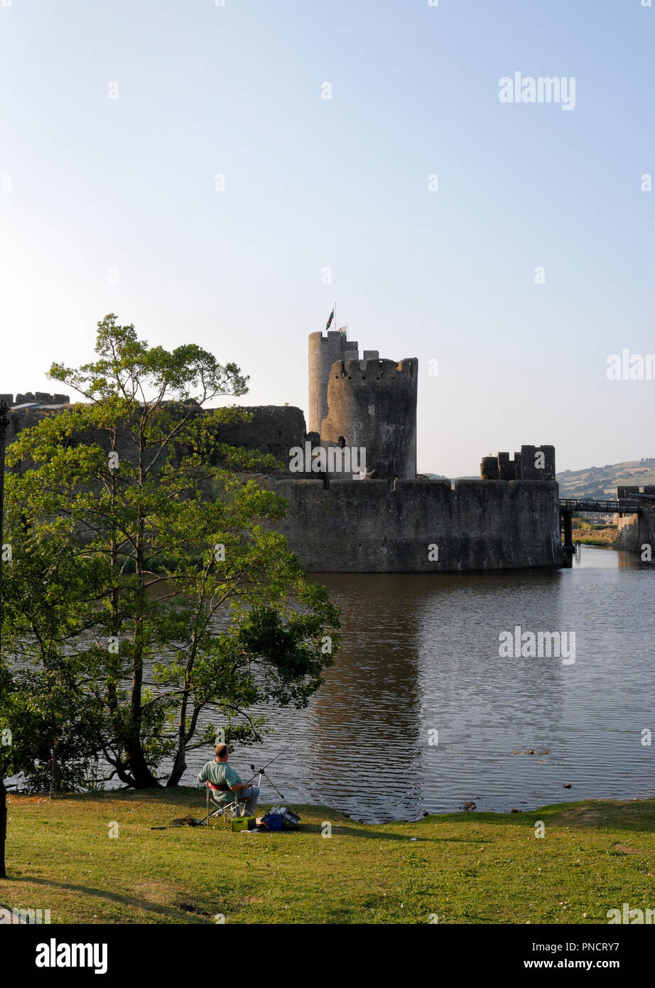 Lone angler at Caerphilly Castle, Wales UK Stock Photo