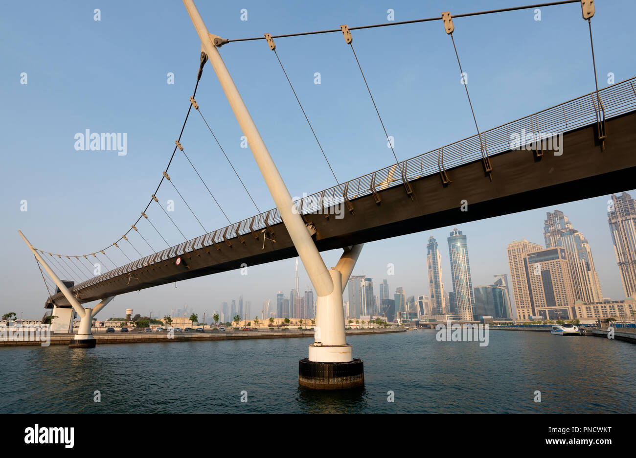 View of footbridge crossing the new Dubai Water Canal a waterway that connects into Dubai Creek and the sea. UAE, United Arab Emirates Stock Photo