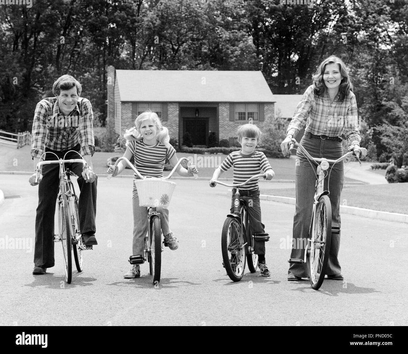 1970s SUBURBAN FAMILY OF FOUR SITTING ON BICYCLES LOOKING AT CAMERA - b25779 HAR001 HARS NOSTALGIC ACTIVE 4 SUBURBAN MOTHERS OLD TIME NOSTALGIA BROTHER OLD FASHION SISTER FITNESS JUVENILE STYLE HEALTHY TEAMWORK SONS PLEASED FAMILIES JOY LIFESTYLE FEMALES STRIPED MARRIED BROTHERS BIKING SPOUSE HUSBANDS HEALTHINESS HOME LIFE FULL-LENGTH PHYSICAL FITNESS DAUGHTERS MALES PLAID SIBLINGS CONFIDENCE BICYCLES SISTERS TRANSPORTATION FATHERS B&W BIKES EYE CONTACT FREEDOM WIDE ANGLE ACTIVITY HAPPINESS PHYSICAL WELLNESS CHEERFUL LEISURE STRENGTH DADS PRIDE OF ON SIBLING SMILES CONNECTION FLEXIBILITY Stock Photo