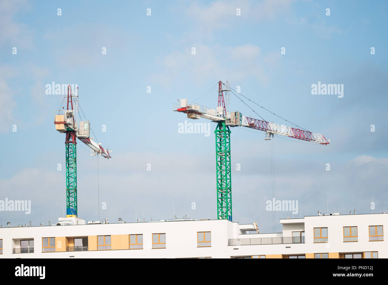 two cranes on the construction site. new buildings are being built Stock Photo