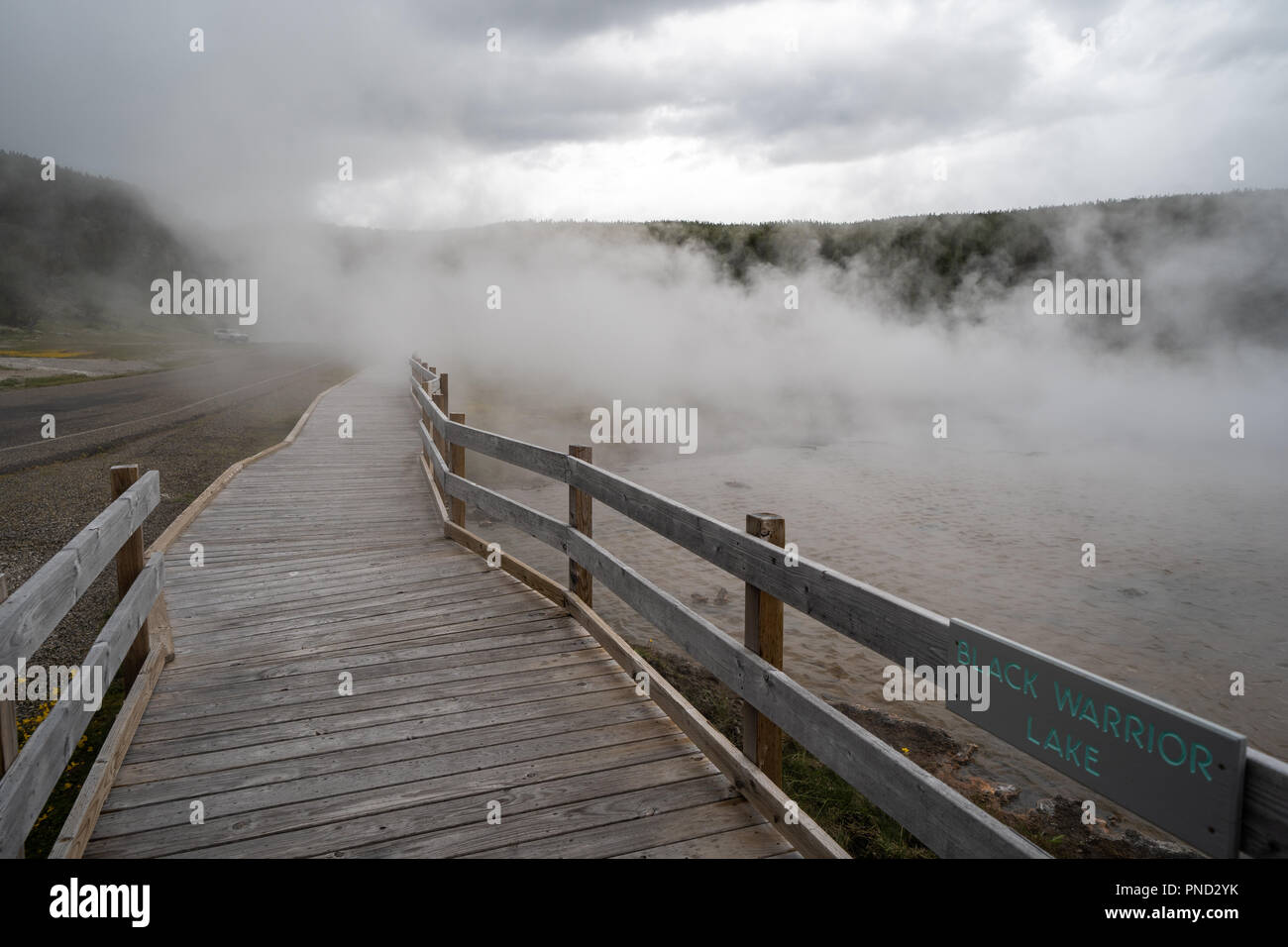 Boardwalk through steam from a thermal feature in Yellowstone National Park Stock Photo
