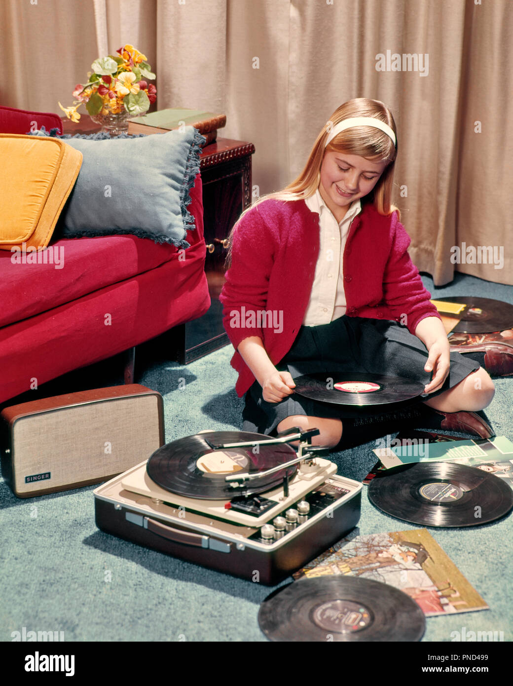 1960s BLONDE TEEN GIRL LISTENING TO LP ALBUMS 33 1/3 RPM PORTABLE RECORD PLAYER  - km3166 PHT001 HARS PERSONS INSPIRATION TEENAGE GIRL ENTERTAINMENT HEADBAND PORTABLE PHONOGRAPH HAPPINESS LEISURE RPM HIGH TECH CONNECTION KNEE SOCKS STYLISH TEENAGED LP CARDIGAN GROWTH JUVENILES ALBUMS CAUCASIAN ETHNICITY OLD FASHIONED Stock Photo