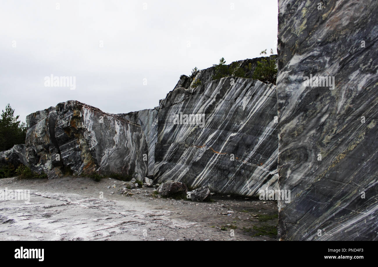 gray natural marble with white streaks in the canyon, deposit, Karelia Stock Photo