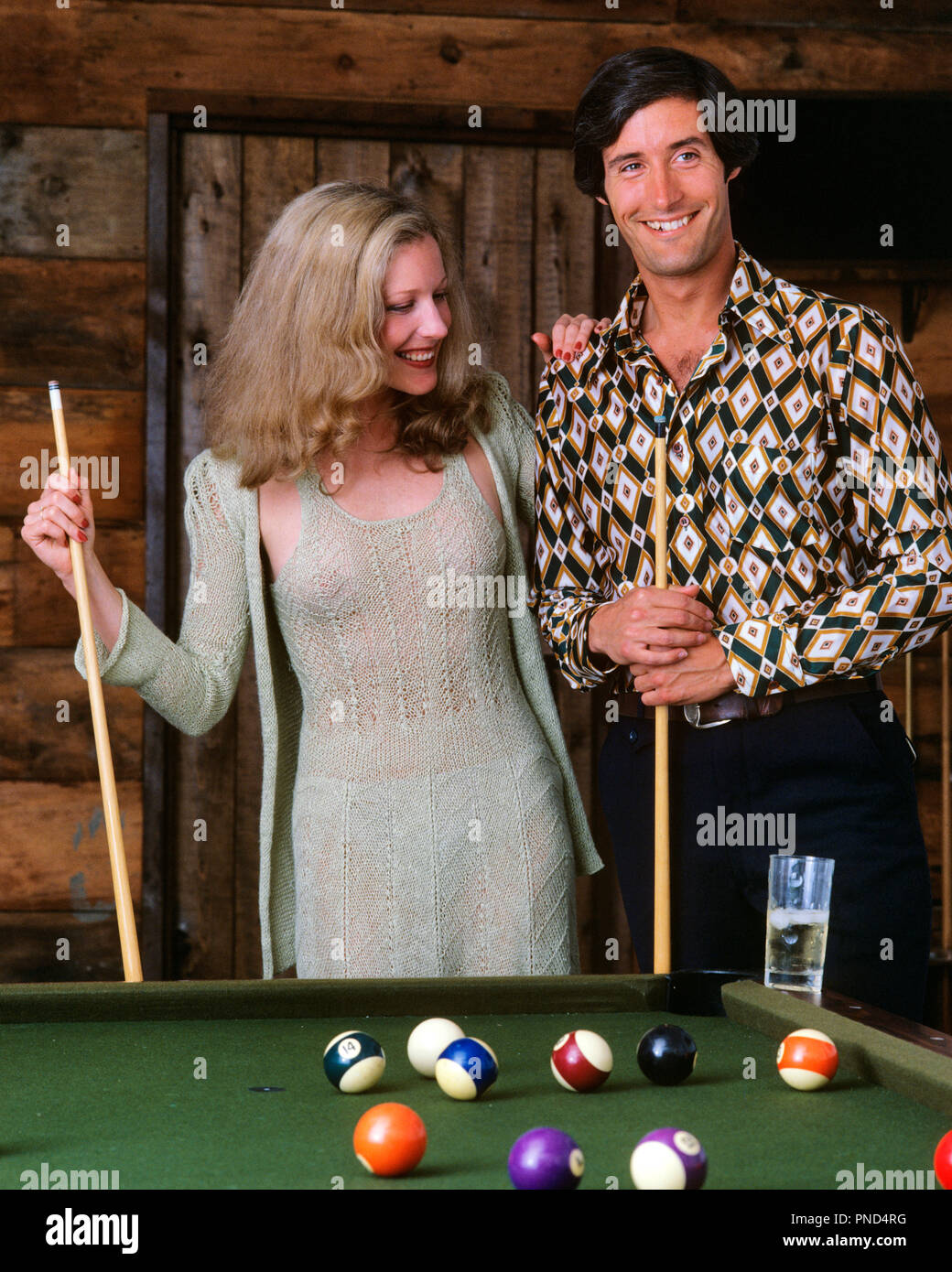 1970s COUPLE AT BILLIARD POOL TABLE IN RECREATION ROOM SPORTS MAN WOMAN  - ks21652 PHT001 HARS YOUNG ADULT SEXY TEAMWORK COMPETITION JOY LIFESTYLE FEMALES SPOUSE HUSBANDS GROWNUP HEALTHINESS HOME LIFE COPY SPACE FRIENDSHIP HALF-LENGTH PERSONS GROWN-UP HUSBAND AND WIFE MEN AND WOMEN TABLES HUSBANDS AND WIVES GOALS SPOUSES ACTIVITY HAPPINESS MATES LEISURE MATE EXCITEMENT RECREATION MAN AND WOMAN SMILES CONNECTION BILLIARDS MANLY STICKS STYLISH ACTIONS COOPERATION PEOPLE ADULTS POOL TABLE QUEUE TOGETHERNESS WIVES YOUNG ADULT MAN YOUNG ADULT WOMAN YOUNGSTER BILLIARD CAUCASIAN ETHNICITY Stock Photo