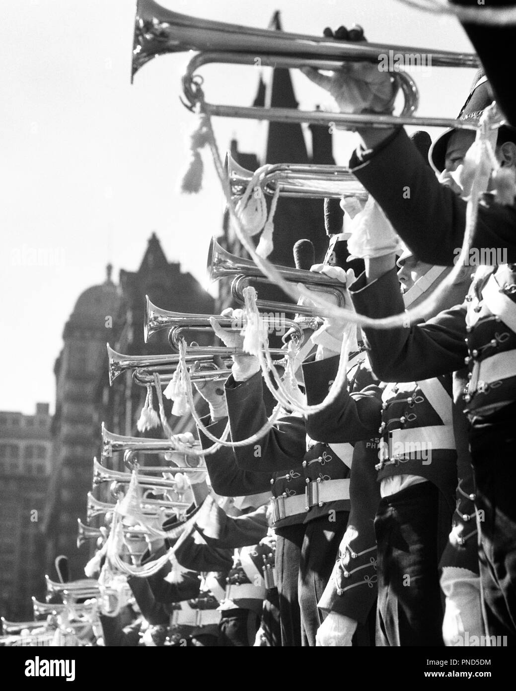 1930s MUSICAL INSTRUMENTS MARCHING MILITARY BRASS BAND IN UNIFORMS HERALDING PLAYING FLOURISHES ON BUGLES - m4476 HAR001 HARS B&W HORNS FREEDOM PERFORMING OCCUPATION HAPPINESS UNIVERSITIES CAREERS LOUD LOW ANGLE PRIDE ON OCCUPATIONS HERALDING HIGHER EDUCATION CADETS COLLEGES BUGLE SYMBOLIC COOPERATION CORPS PAGEANTRY PLAYED PRECISION TOGETHERNESS YOUNG ADULT MAN BLACK AND WHITE BUGLES CEREMONIAL HAR001 OLD FASHIONED PARADES REPRESENTATION TRUMPETS Stock Photo