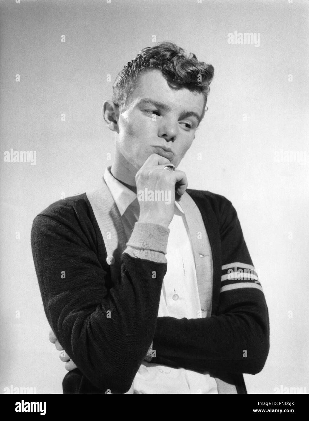 1950s thoughtful thinking teen boy wearing varsity sweater - p1811