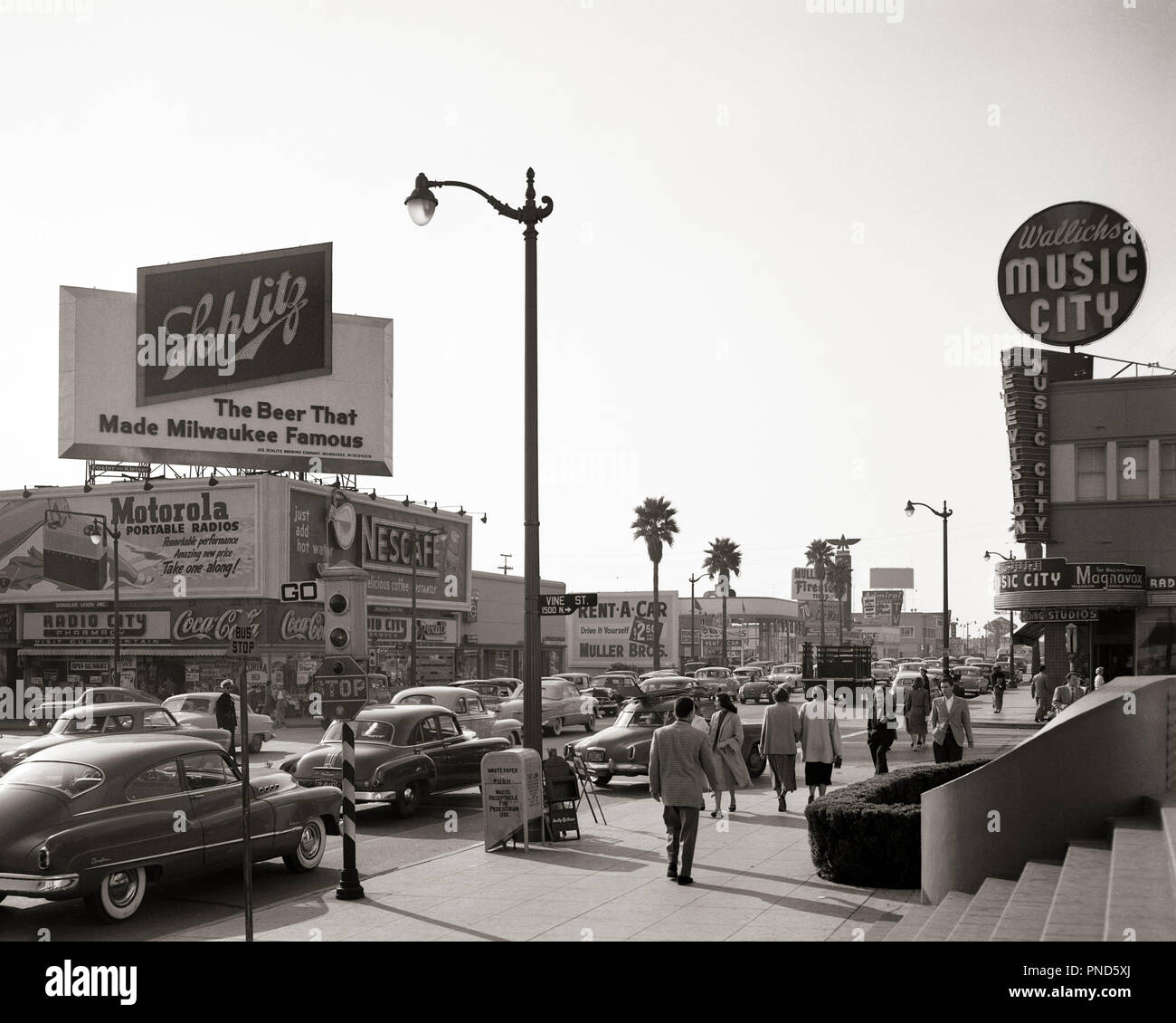 1950s BUSY STREET SCENE SUNSET BOULEVARD AND VINE STREET HOLLYWOOD CALIFORNIA LOOKING WEST FROM NBC BUILDING  - q53016 HAR001 HARS LOS ANGELES OLD FASHIONED Stock Photo