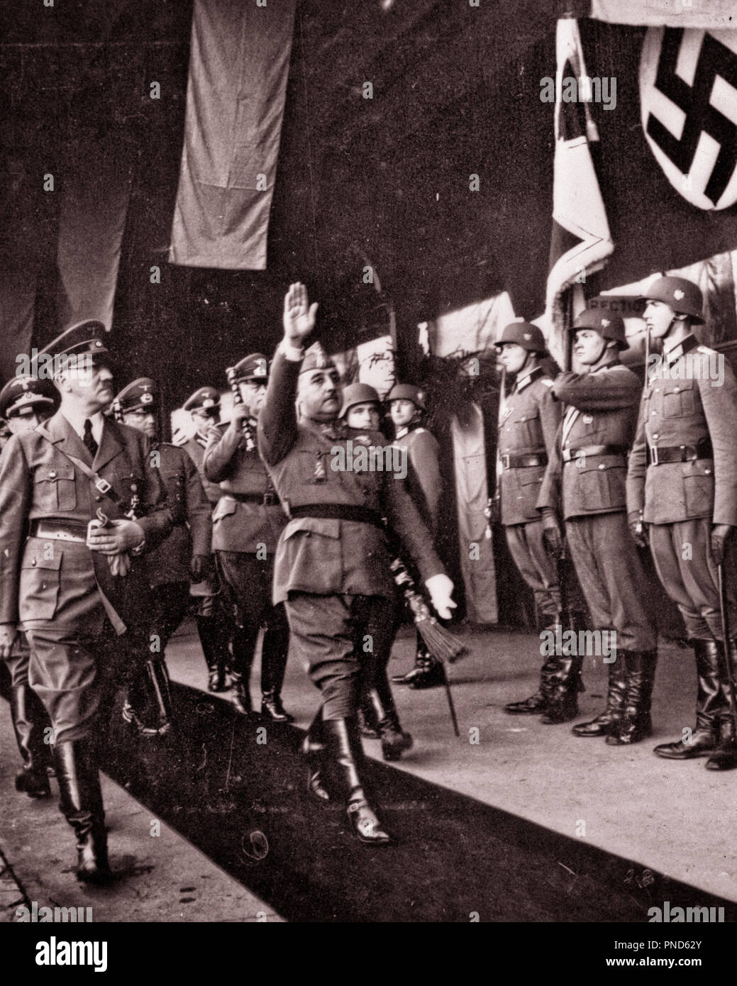 1940 OCTOBER 23 HITLER MARCHES AS FRANCO SALUTES DURING HITLER’S TRIP TO SPAIN ITALY AND FRANCE FROM VON RIBBENTROP PHOTO ALBUM - q74015 CPC001 HARS NATIONALISM POWERFUL WORLD WARS ITALY WORLD WAR WORLD WAR TWO WORLD WAR II DICTATOR SWASTIKA OCCUPATIONS POLITICS UNIFORMS NAZI VISIT WORLD WAR 2 FASCIST ADOLF HITLER PHOTO ALBUM FASCISM TOGETHERNESS BLACK AND WHITE CAUCASIAN ETHNICITY DURING OLD FASHIONED Stock Photo