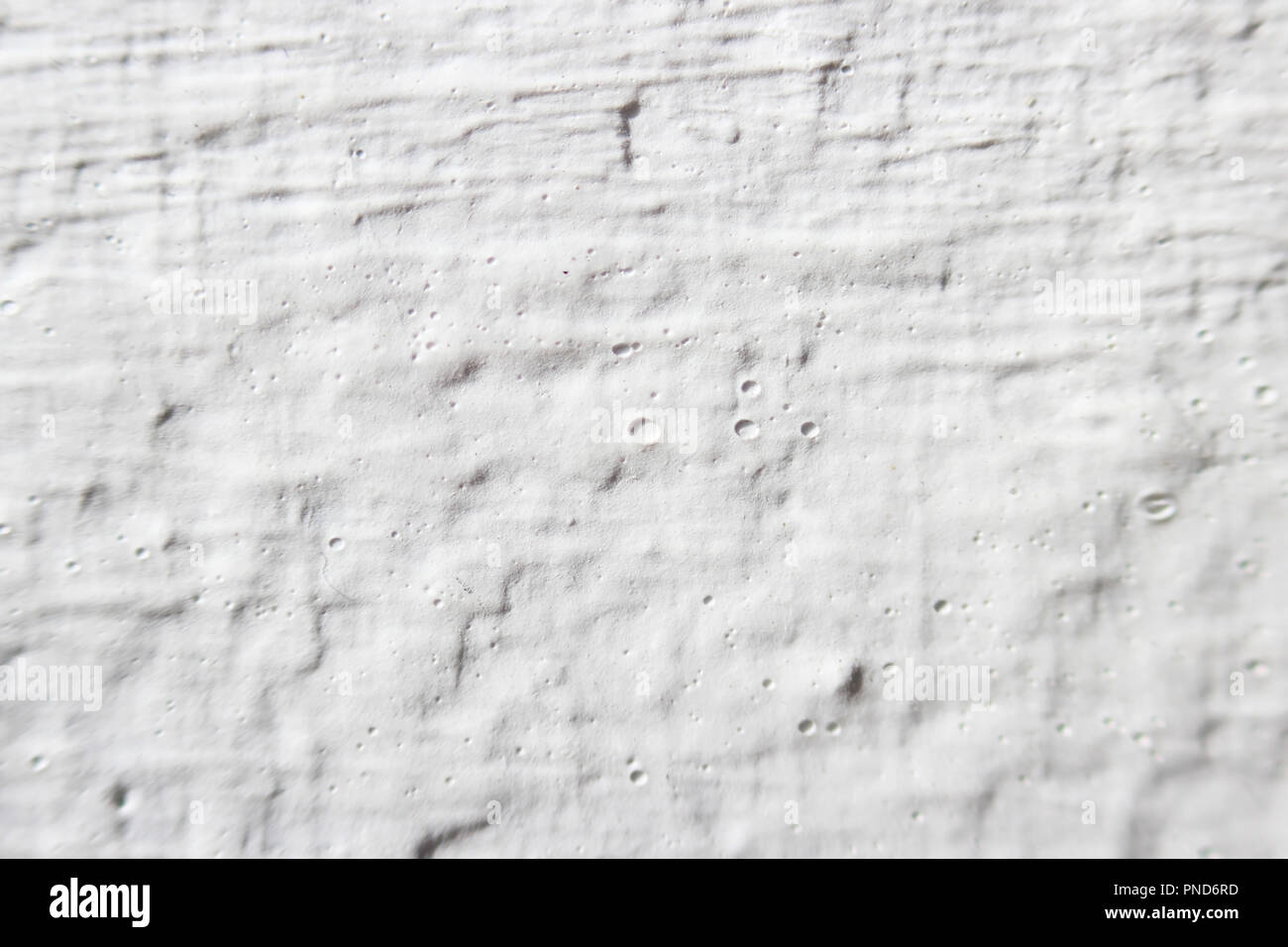 Decorative plaster effect on wall. white plaster lighted by daylight Stock Photo