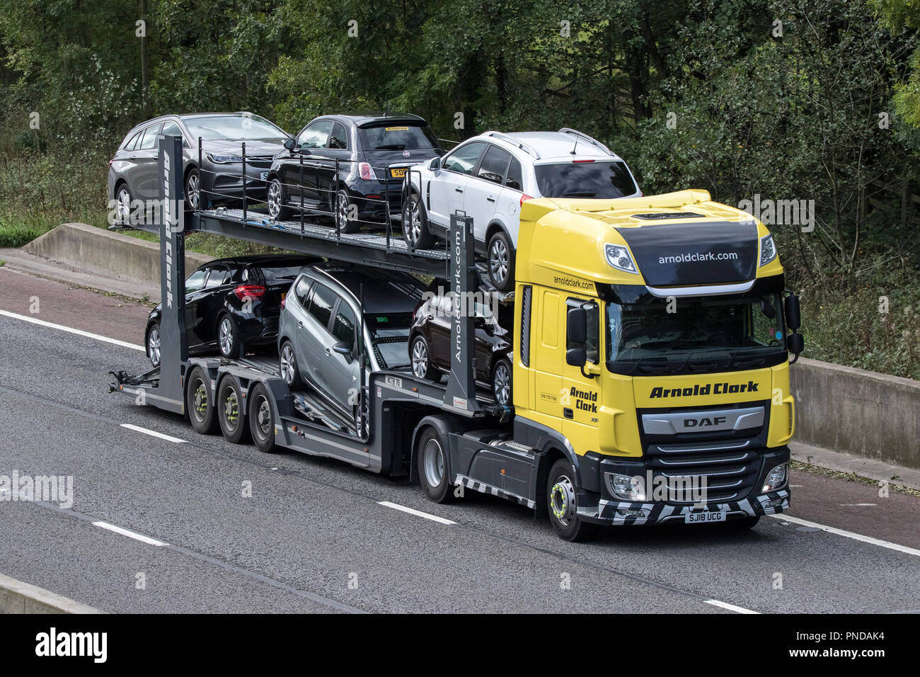 Arnold Clark car transporter, HGV Heavy goods lorries, vehicle carrying  trucks & trucking, logistics transport vehicles on the M6 at Lancaster, UK Stock Photo