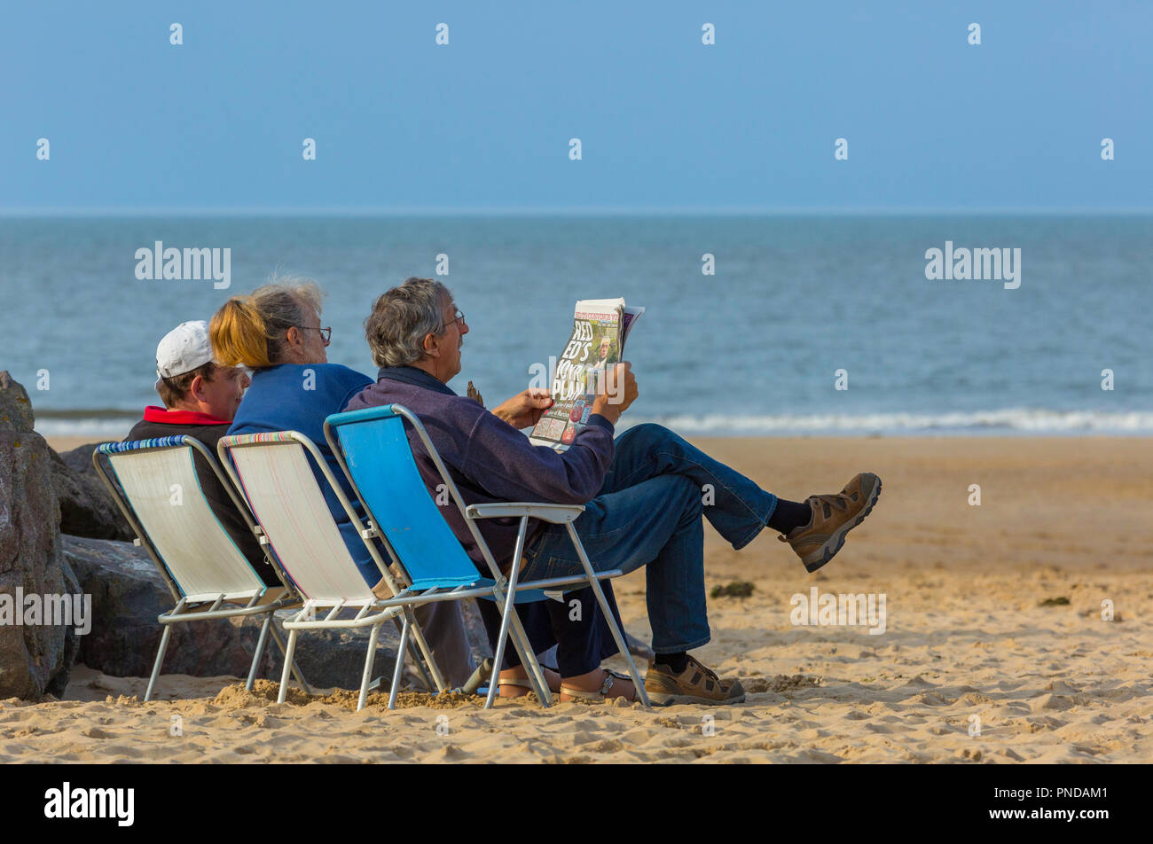 Relaxing on the beach at the end of summer. Stock Photo