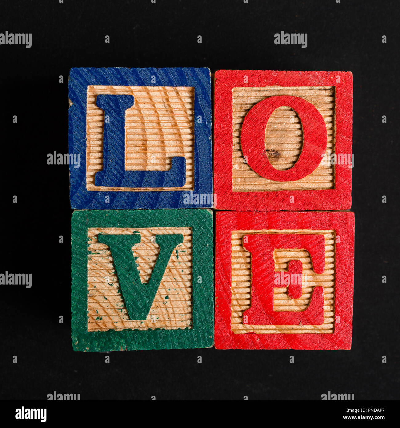 The word love spelt out in a child's toy wooden blocks. Stock Photo