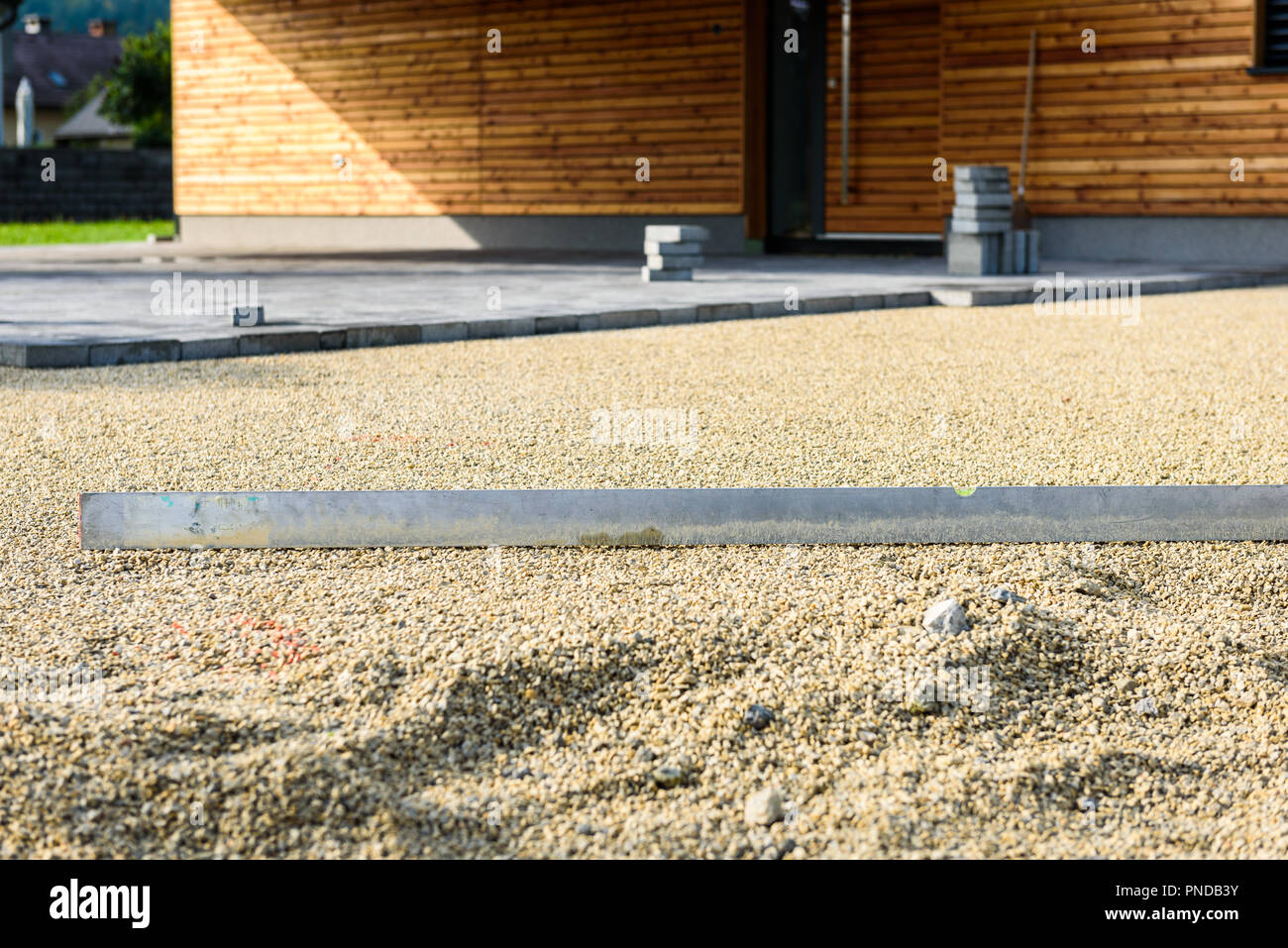 Laying gray concrete paving slabs in house courtyard driveway patio