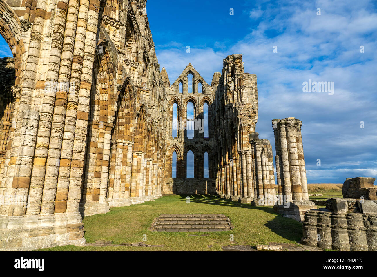 Whitby Abbey North Yorkshire Coast UK. Perched high on a cliff, the haunting remains of Whitby Abbey were inspiration for Bram Stoker's gothic tale of Stock Photo