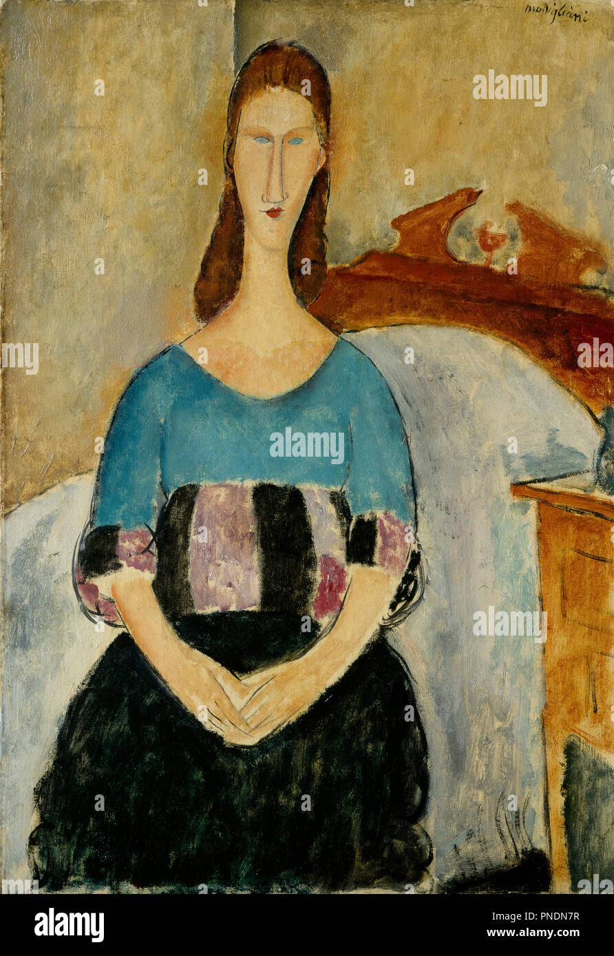 Portrait of Jeanne Hebuterne, Seated, 1918. Date/Period: 1918. Painting. Oil on canvas Oil on canvas. Height: 550 mm (21.65 in); Width: 380 mm (14.96 in). Author: Amedeo Modigliani. Stock Photo