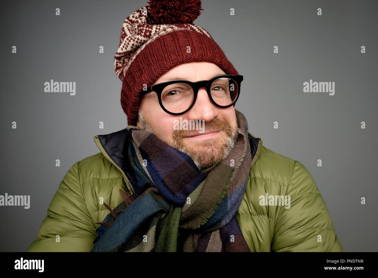 Portrait of a handsome young man smiling wearing warm winter coat ...