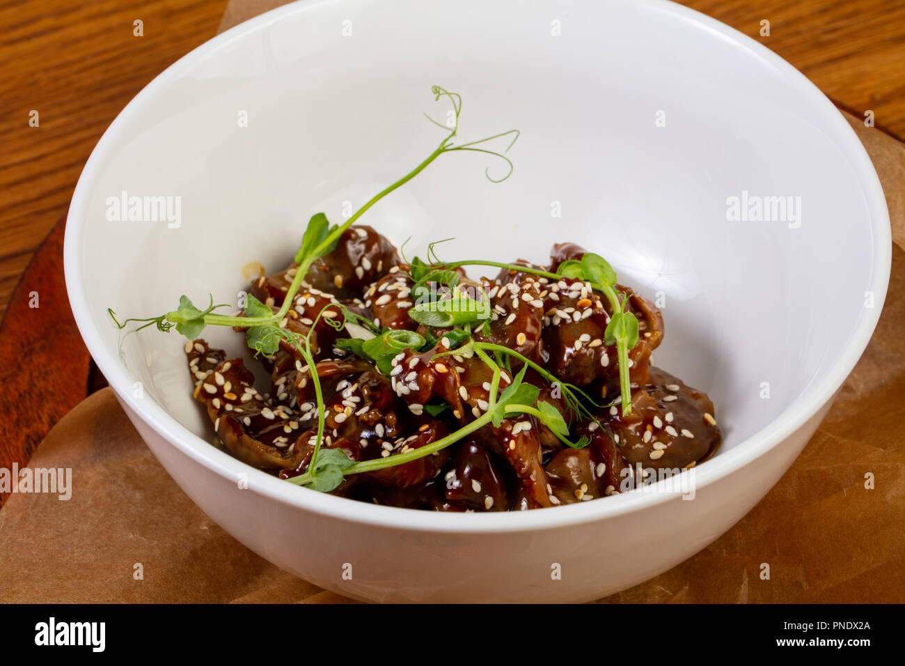 Roasted chicken giblets served sesam seeds Stock Photo Alamy