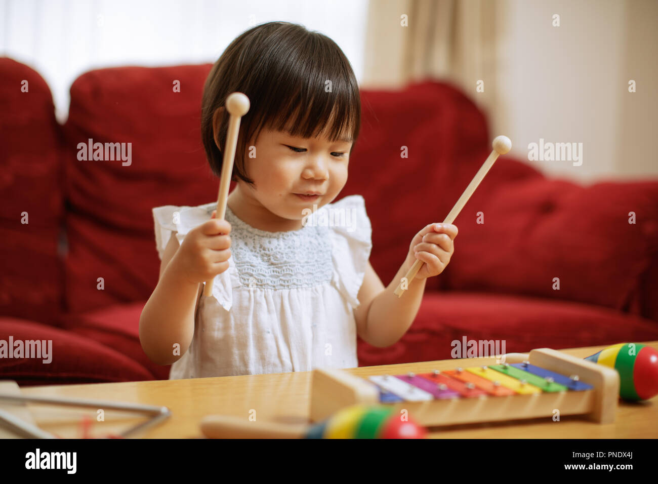 baby girl play xylophone at home Stock Photo Alamy