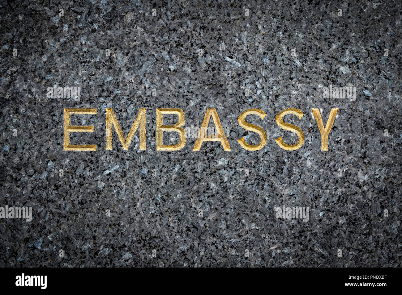A Gold Embossed Embassy Sign On Marble Stock Photo