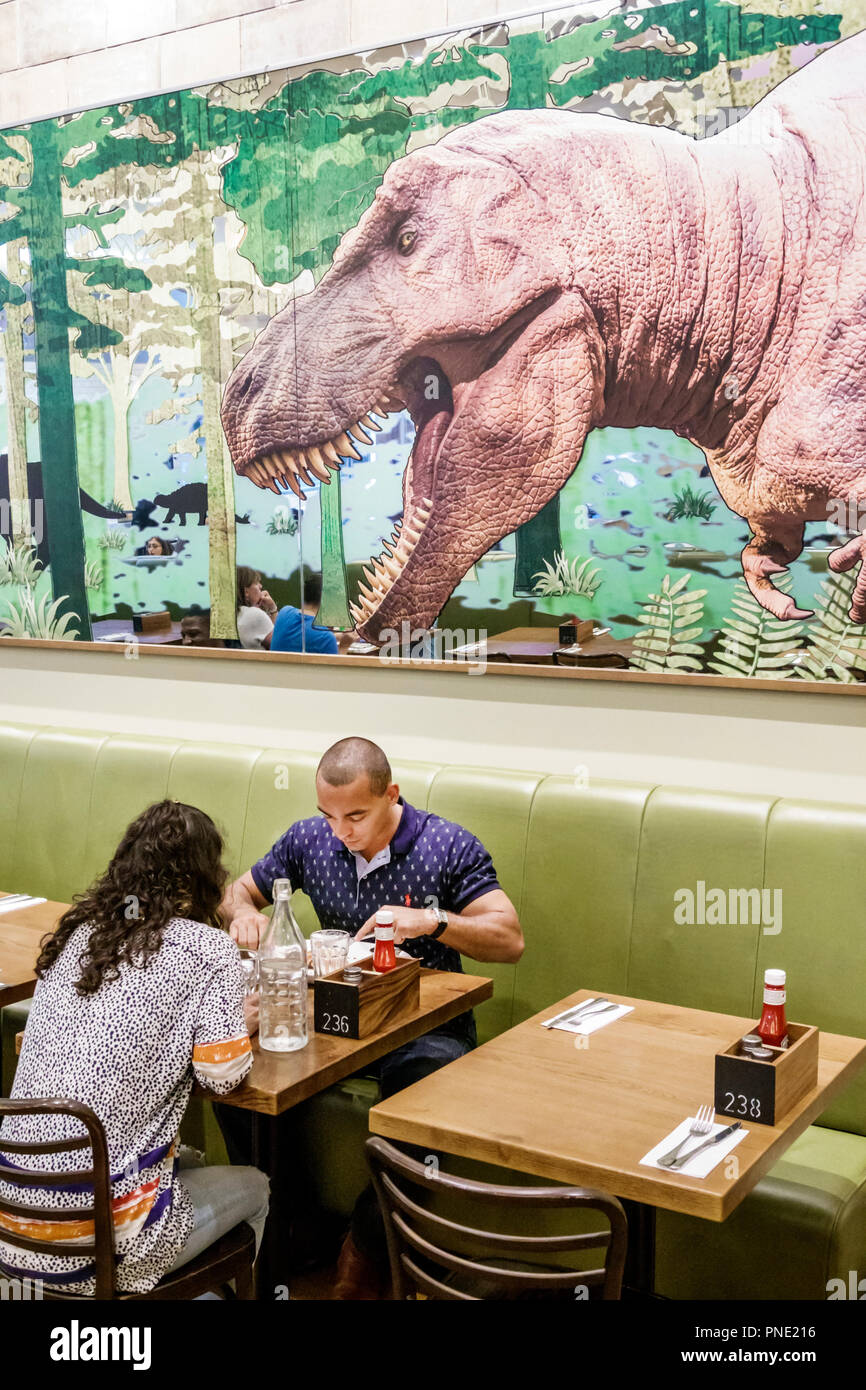 London England,UK,Kensington,Natural History Museum,inside interior,T. rex Grill,restaurant restaurants food dining cafe cafes,dining,booth,table,man Stock Photo