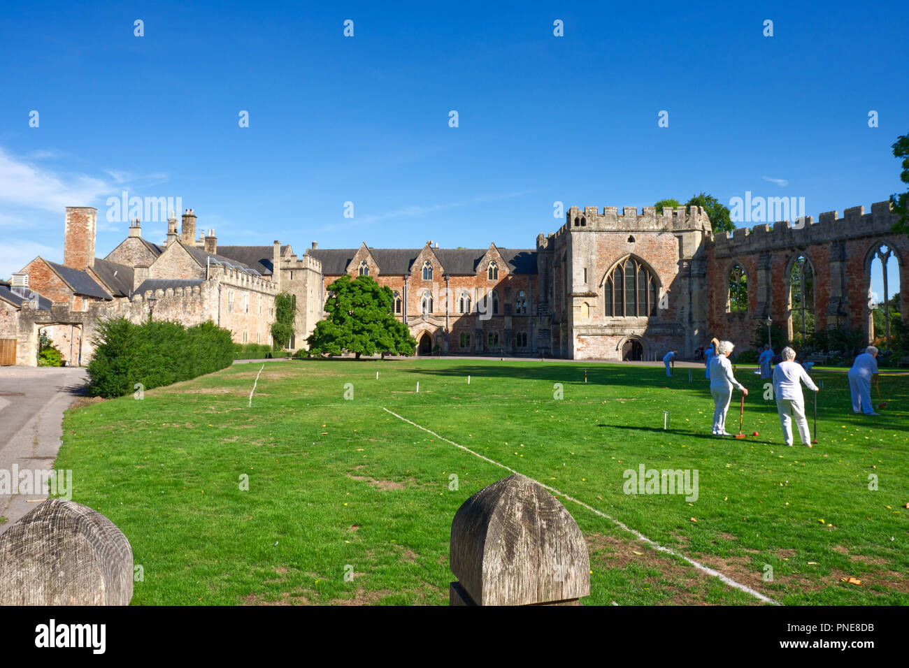 Ladies playing Croquet on the front lawn at the Bishop's Palace,Wells, Somerset, UK. Stock Photo