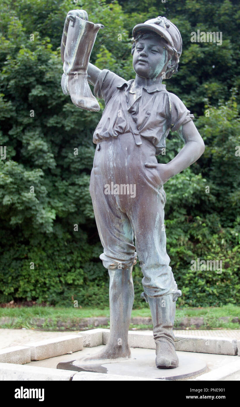 Boy and Boot statue in Wellsville, Ohio—charming and curious small-town sculpture that sparks stories and sidewalk smiles. Stock Photo