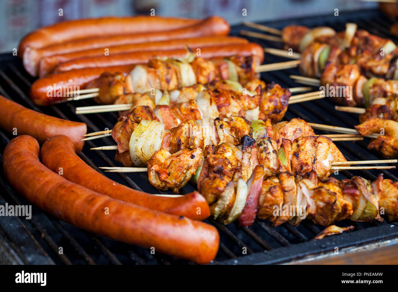 Grilled sausages and chicken skewers Stock Photo