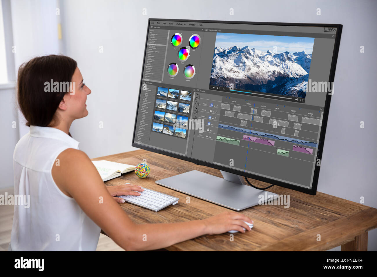 Female Editor Editing Video On Computer Over Wooden Desk Stock