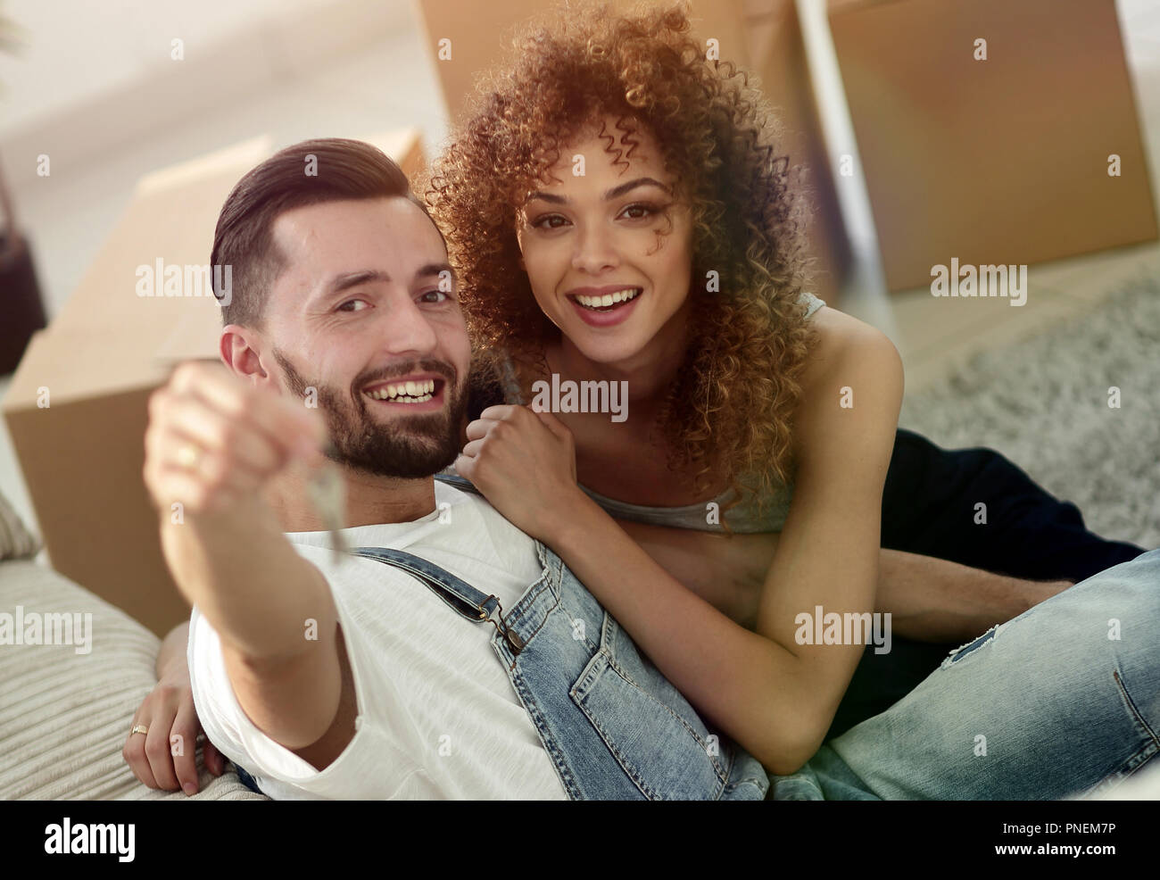 young couple holding the key to a new apartment Stock Photo - Alamy