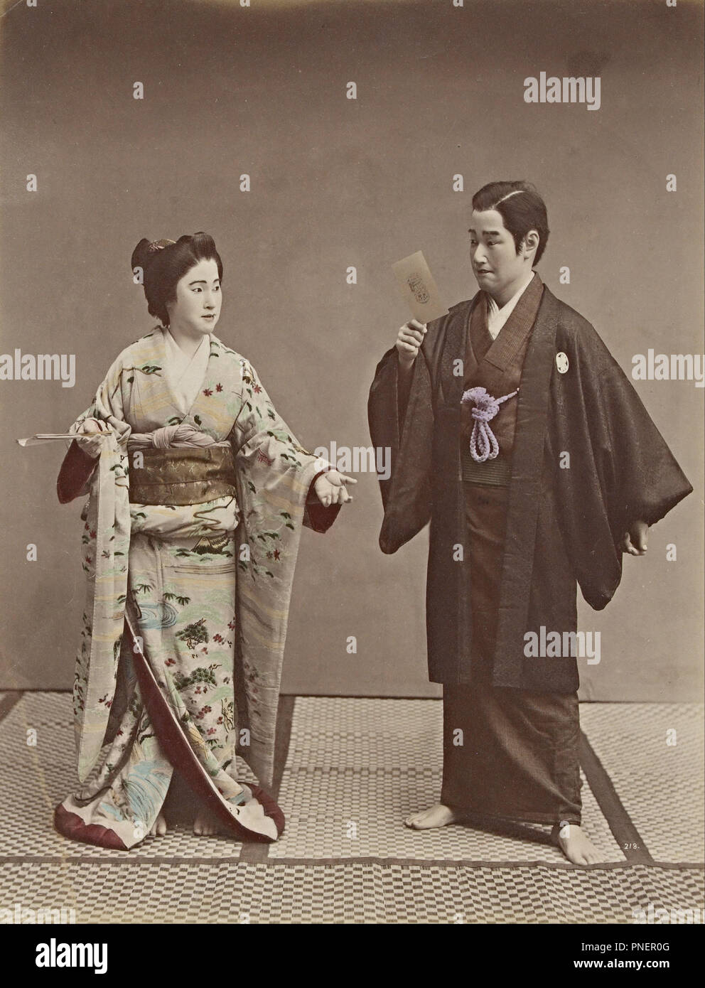 No title (Couple with a cabinet photograph and ghost in background). Date/Period: 1880s. Photographyy. Albumen silver photograph, colour dyes albumen silver photograph, colour dyes. Height: 265 mm (10.43 in); Width: 204 mm (8.03 in). Author: Kusakabe Kimbei. Stock Photo
