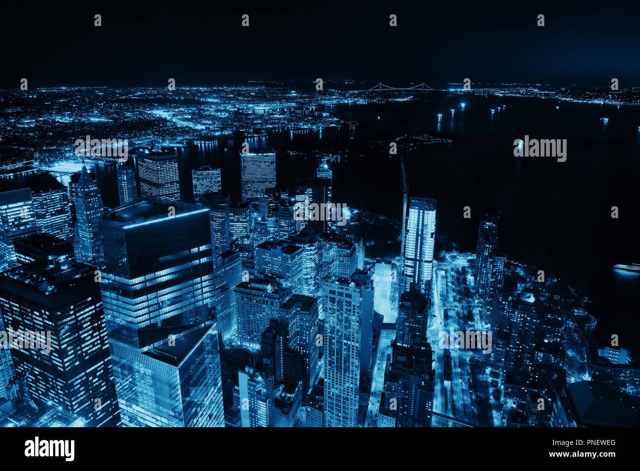Rooftop night view of New York City downtown with urban skyscrapers