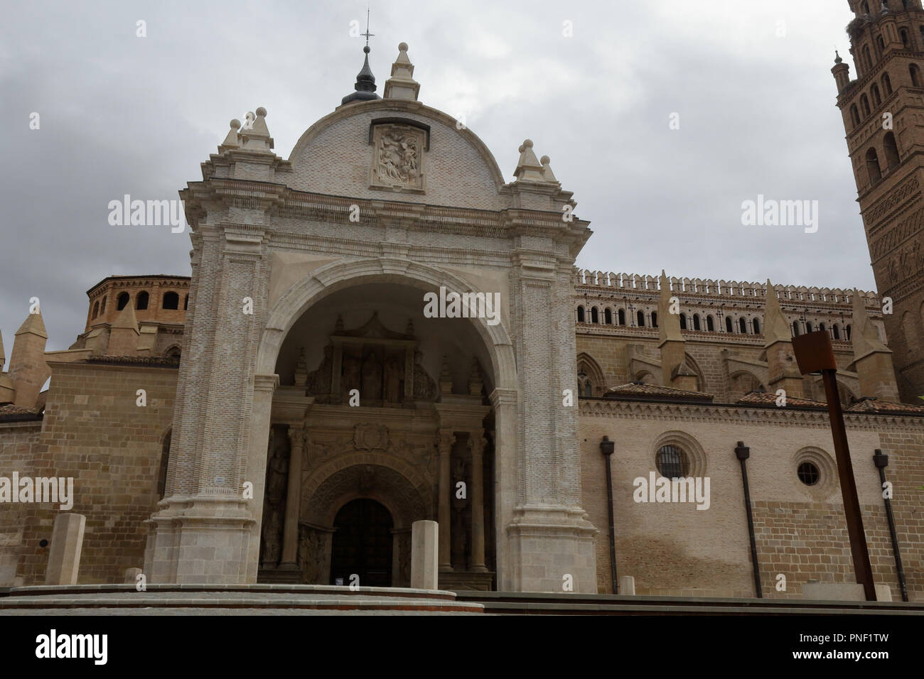 The Nuestra Señora de la Huerta gothic and mudejar cathedral facade, seen from the entrance staircase, in a cloudy, autumn day in Tarazona, Spain Stock Photo