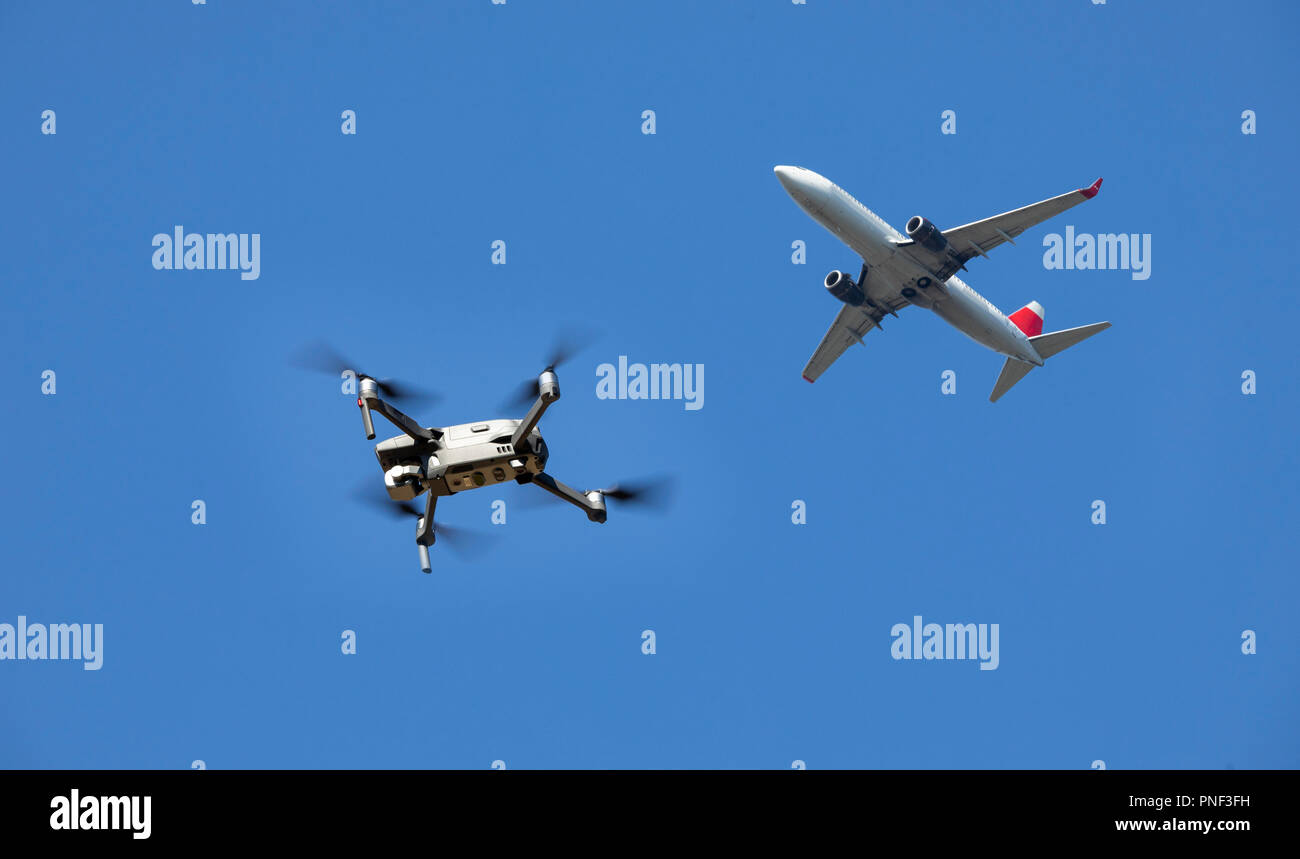Drone, quadrocopter, DJI Mavic 2 PRO, flies, above a passenger plane, in an approach to an airport, photomontage, Stock Photo