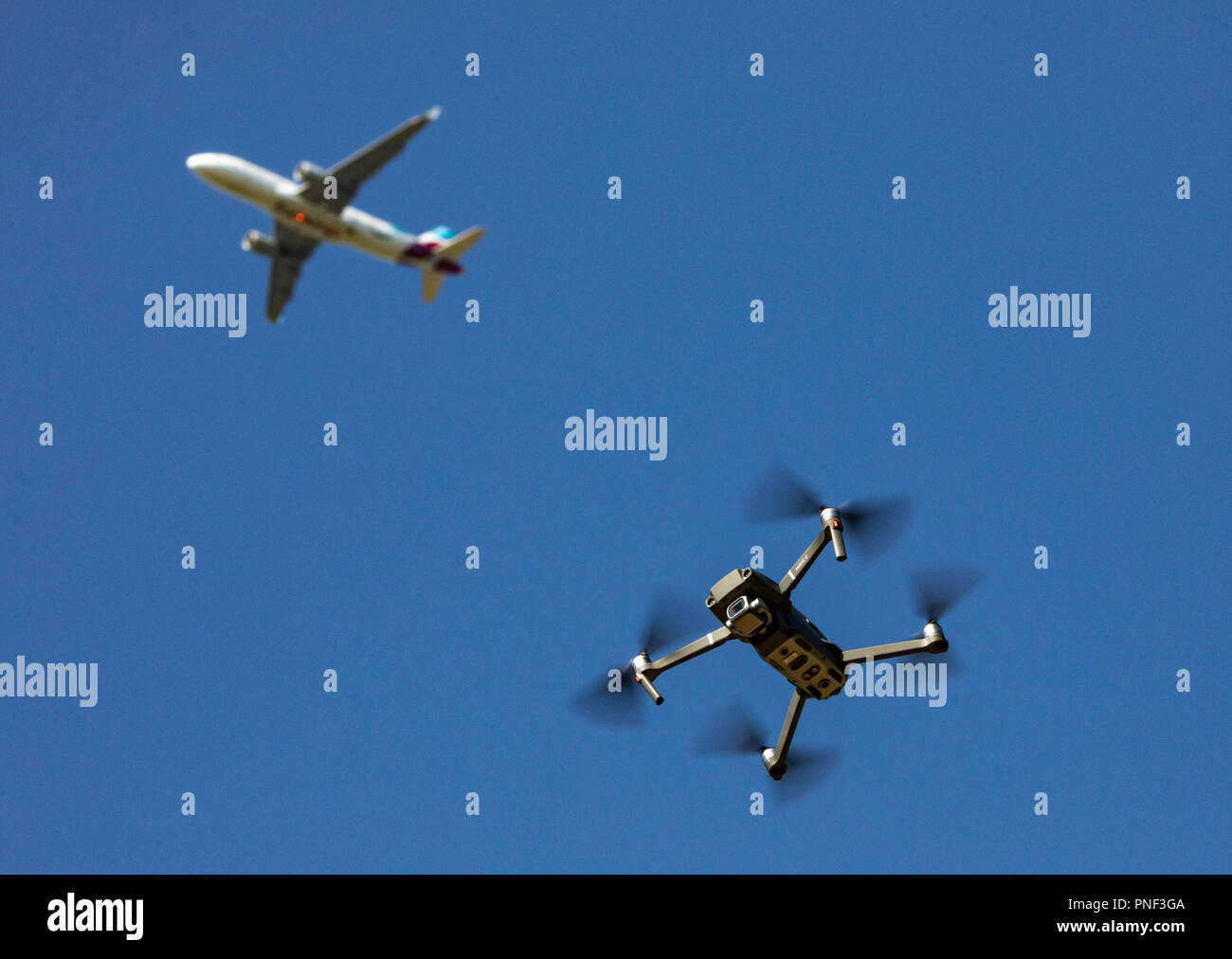 Drone, quadrocopter, DJI Mavic 2 PRO, flies, above a passenger plane, in an approach to an airport, Stock Photo