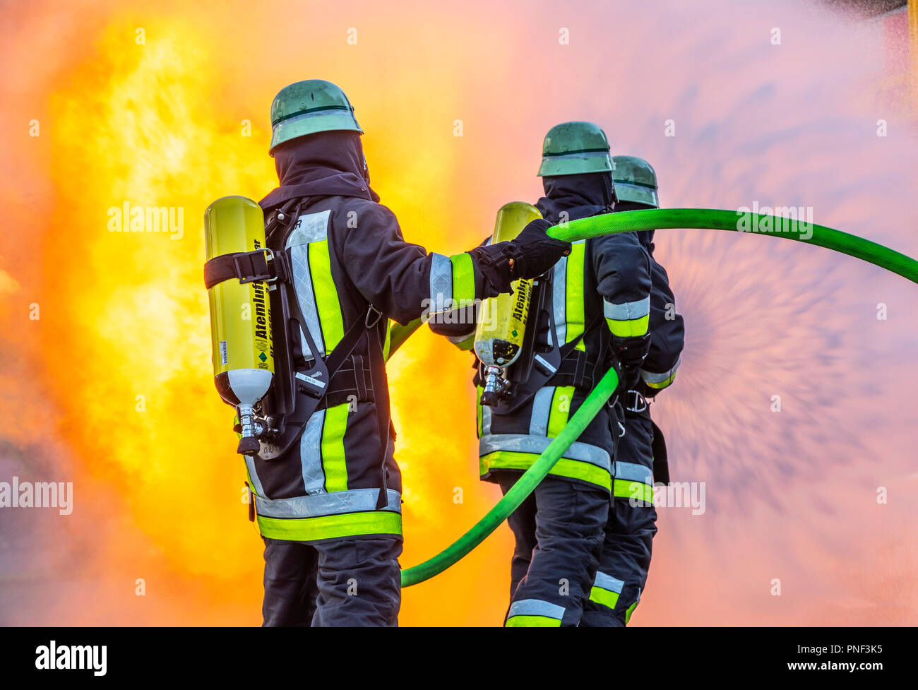 Firefighters in fire fighting, exercise, fire simulator for chemical fires,  fire department Essen, Germany Stock Photo