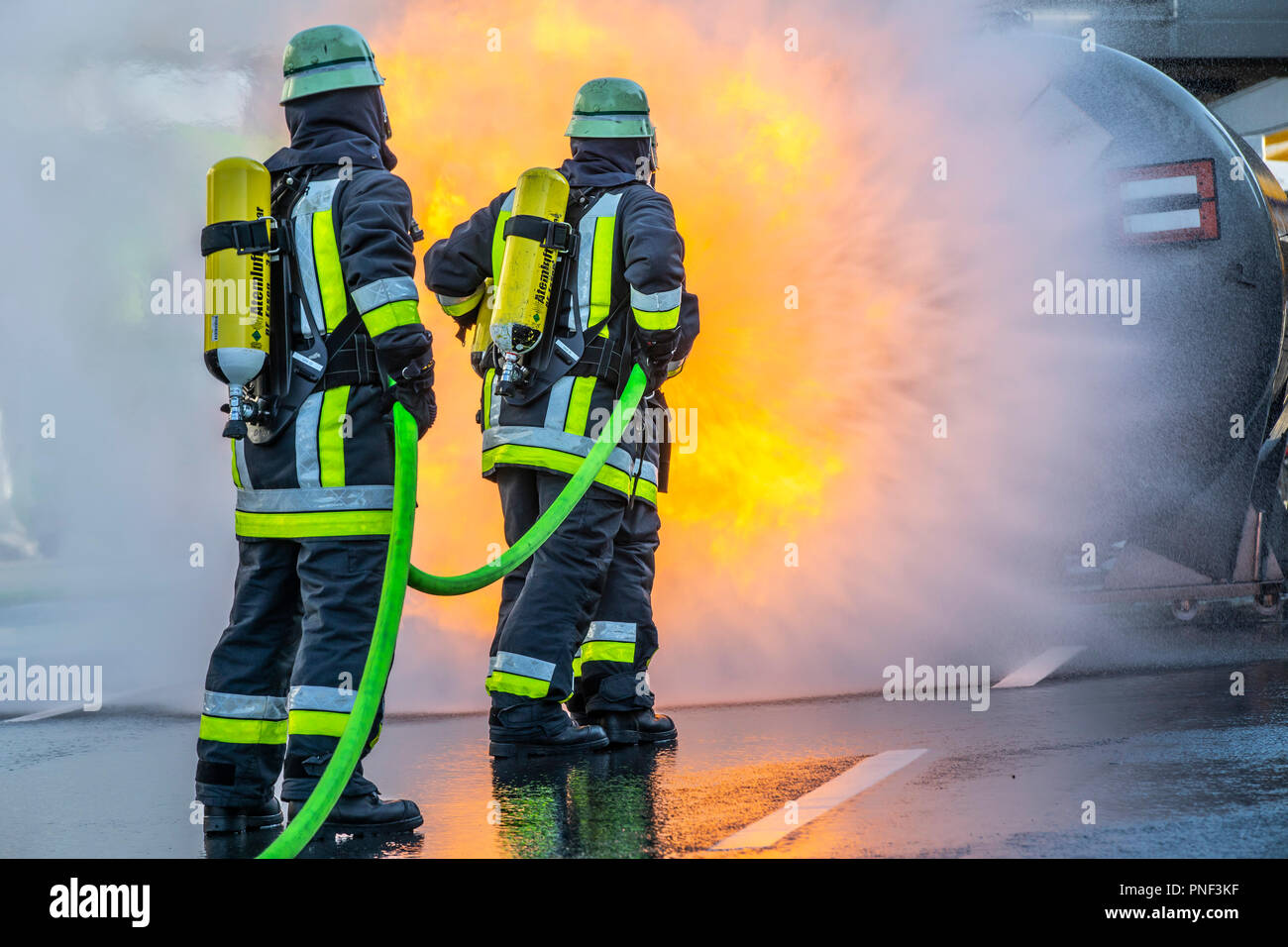 Firefighters in fire fighting, exercise, fire simulator for chemical