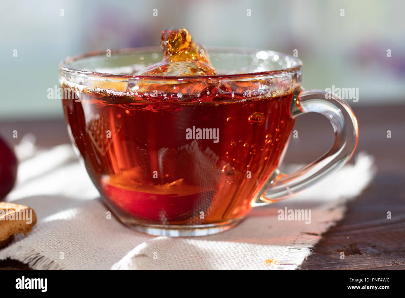 Hot drink. Hot fruit tea in with plums. Plum half in a cup of tea Stock