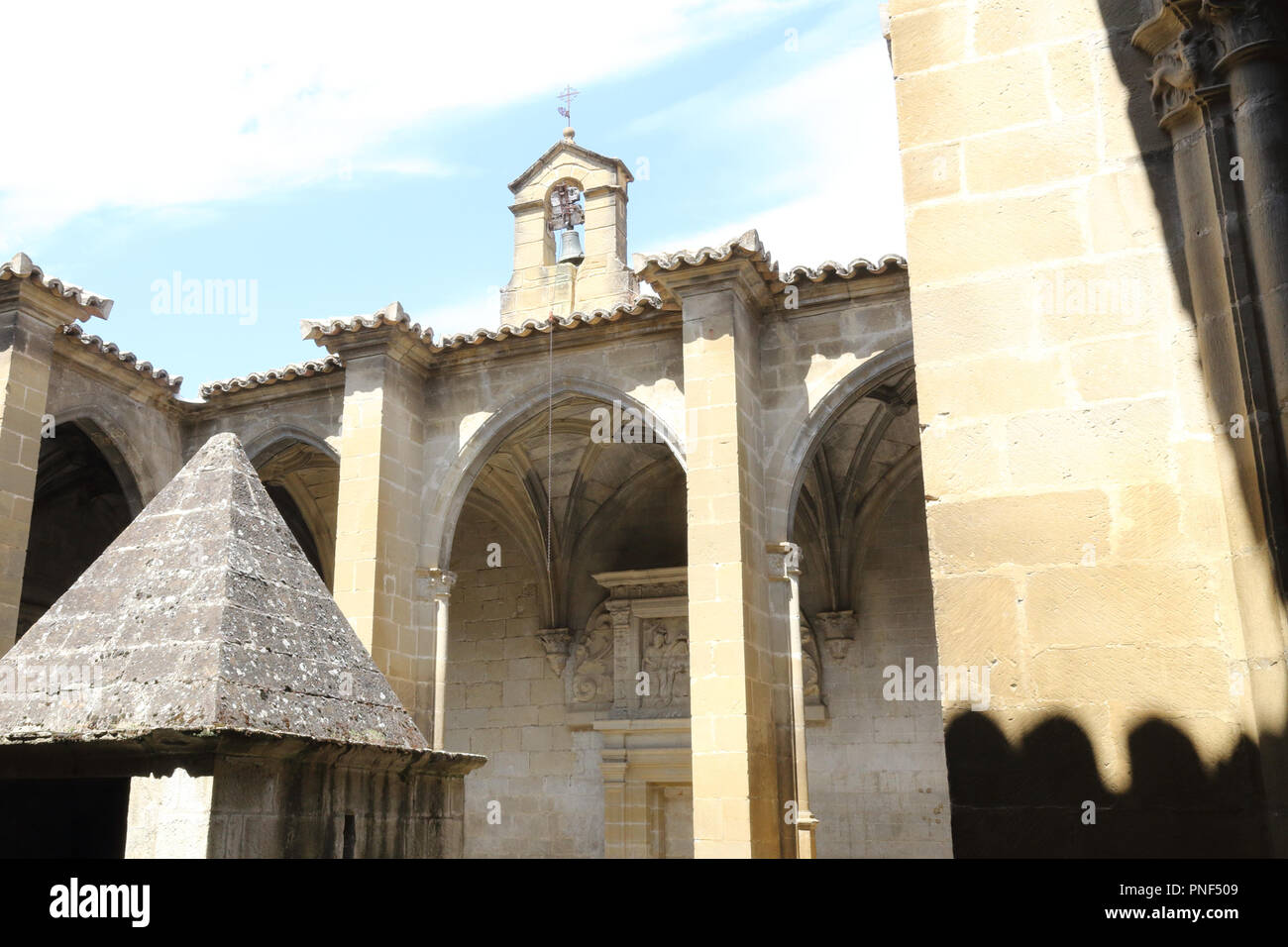 The internal cloister with the bell in the Holy Mary Church (Iglesia de Santa Maria) in Uncastillo, a rural town in the Pre-Pyrenees in Spain Stock Photo