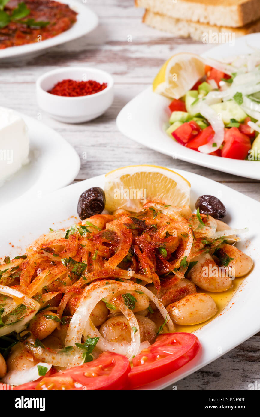 Traditional Turkish salad piyaz with onion, lemon, lettuce and pepper Stock Photo