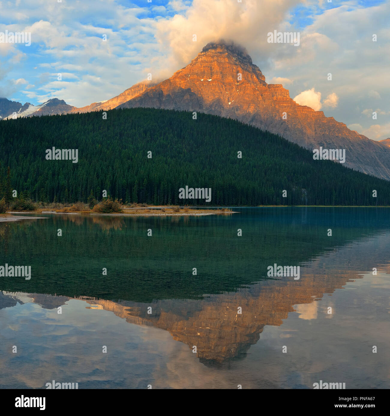 Lake at sunrise with cloud and mountain reflections in Banff National ...
