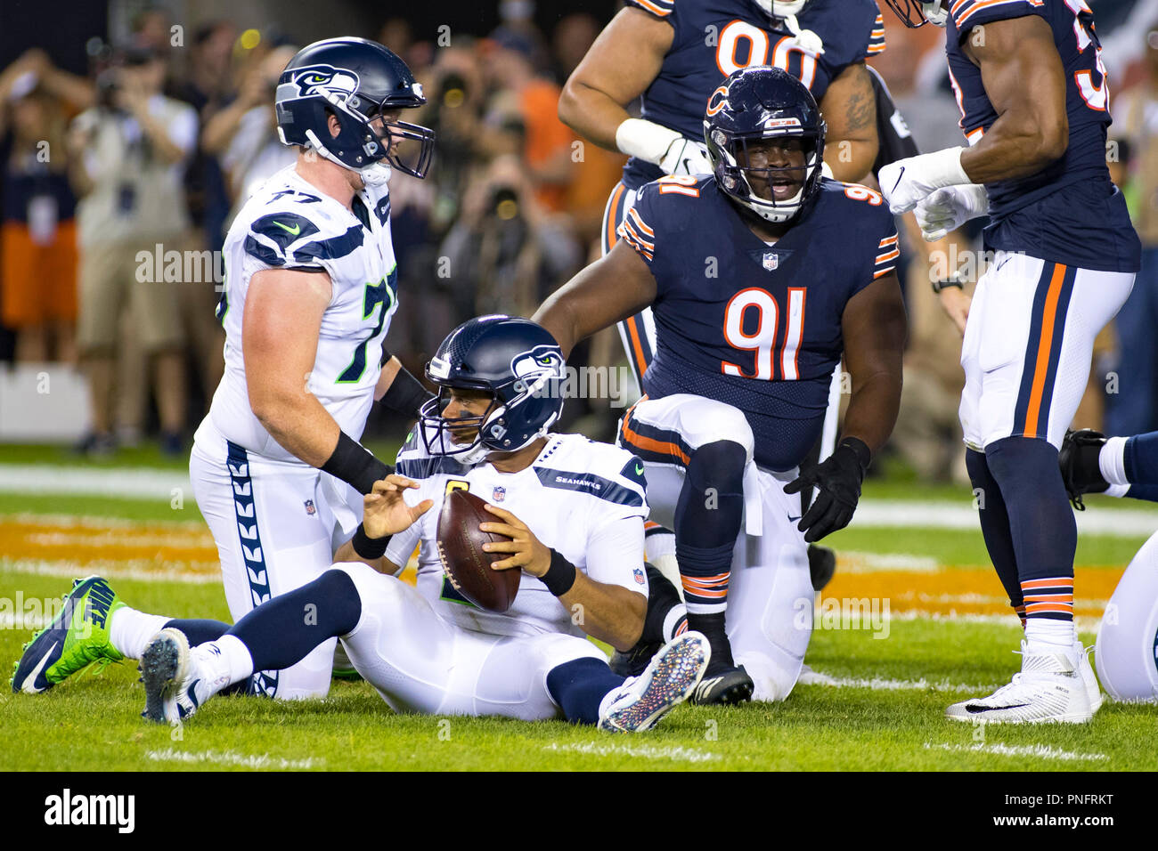 September 17, 2018: Chicago, Illinois, U.S. - Bears #91 Eddie Goldman sacks  Seahawks Quarterback #3 Russell Wilson during the NFL Game between the  Seattle Seahawks and Chicago Bears at Soldier Field in