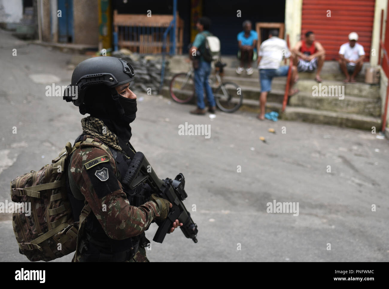 Brazilian Marine Corps (BMC) Cmdr. Gustavo Soares Gomes with BMC  Headquarters is assisted by a U.S. Soldier with 3rd Battalion, 7th Special  Forces Group before parachute training during Tradewinds 2021, Air Station